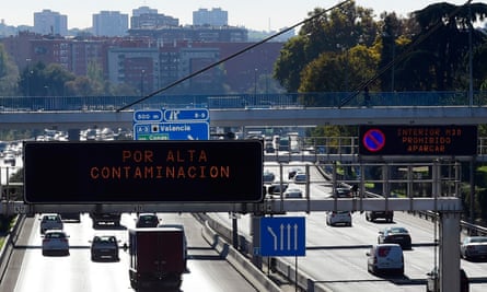 Smog hangs over Mardrid and road signs warn of speed limits in place due to air pollution. About 3,000 people die prematurely in the city every year due to pollution.