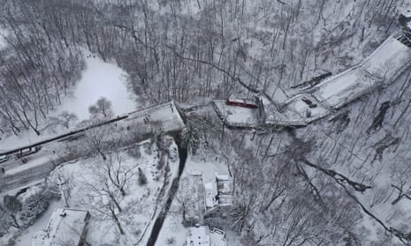 A Port Authority bus that was on the bridge when it collapsed on 28 January is visible through trees in Pittsburgh’s East End. 