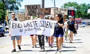 Nicholle Ramsey, right, Mike Leutgeb Munson, center, and Spencer Klausing carry a banner during a peaceful gathering and march, Saturday, July 9, 2016, in Winona, Minn., to support the Black Lives Matter movement and to condemn the killing of Philando Castile. A suburban St. Paul police officer who killed the black driver reacted to the manâs gun, not his race, his attorney said Saturday, giving the most detailed account so far of why the officer drew his own weapon during the traffic stop. (Taylor Nyman/Winona Daily News via AP)