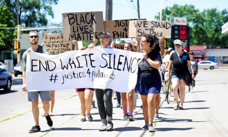 Nicholle Ramsey, right, Mike Leutgeb Munson, center, and Spencer Klausing carry a banner during a peaceful gathering and march, Saturday, July 9, 2016, in Winona, Minn., to support the Black Lives Matter movement and to condemn the killing of Philando Castile. A suburban St. Paul police officer who killed the black driver reacted to the man’s gun, not his race, his attorney said Saturday, giving the most detailed account so far of why the officer drew his own weapon during the traffic stop. (Taylor Nyman/Winona Daily News via AP)