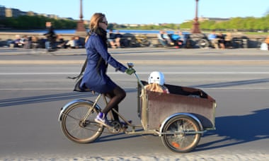 A mother and her child using a cargo bike