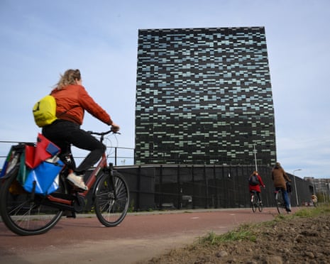 A woman rides past Nexperia headquarters in Nijmegen