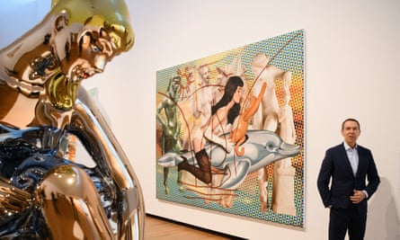 Jeff Koons beside his painting of Antiquity 2, depicting Gretchen Mol as Bettie Page.
