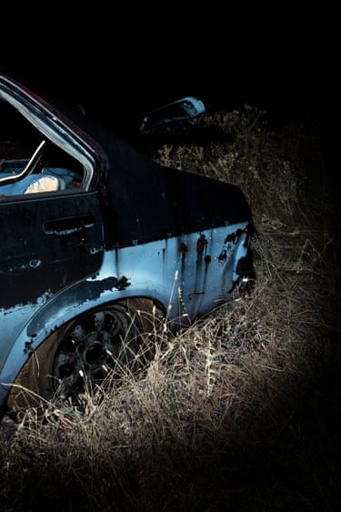 Back of a damaged car in a field