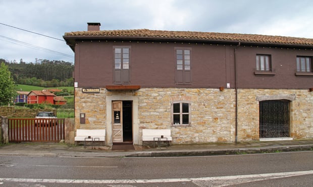 Exterior shot of the stone and wood building that houses Soda 917 in Villaviciosa, Asturias. The unassuming tobacco shop is famous for its cocktails.