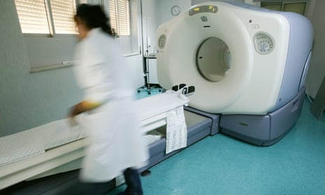 Blurred person next to a PET scanner