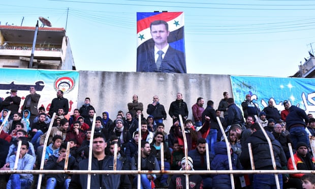 A portrait of Syrian president Bashar al-Assad hangs in the stadium during a football match between derby rivals Al-Ittihad and Al-Hurriya last month
