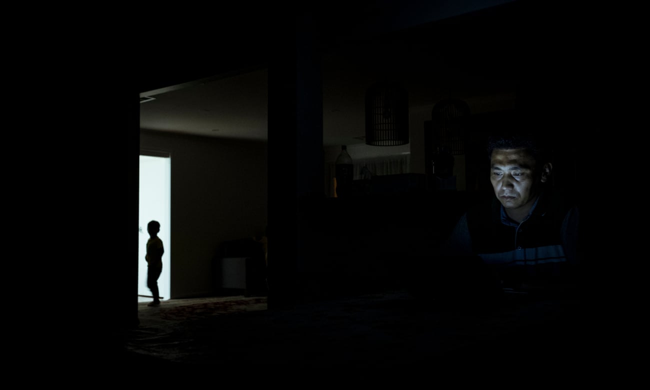 Noor works on his book of short stories as Daniel lingers in a doorway