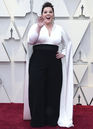 Monochrome dressing can be hit and miss. Melissa McCarthy manages it with her palazzo pants, and billowy cape-style blouse. A statement outfit which combines several trends, and McCathy is having all kinds of fun in it