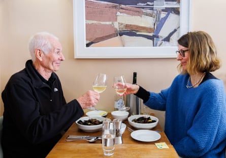 A man and woman facing each other across a restaurant table