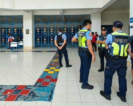 Philippine police gather at the school in Zamboanga after the shooting