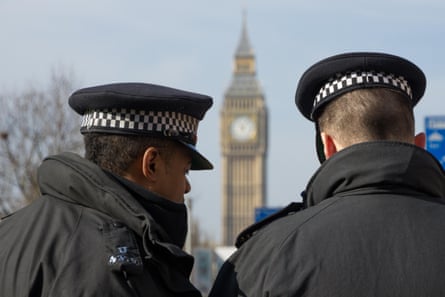Back view of two Met police officers facing Big Ben