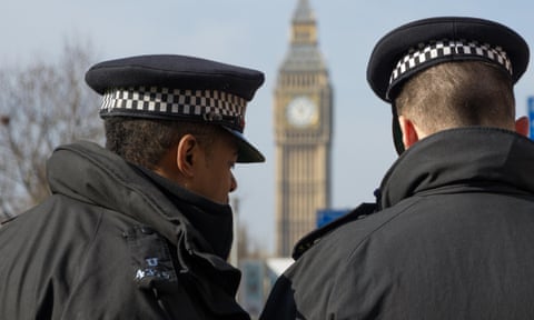 Two London Metropolitan Police Officers overlooking Big Ben