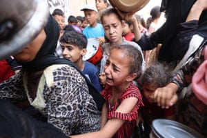 a girl crying with lots of other people around her