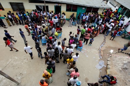 People wait to vote at a polling station in Monrovia.