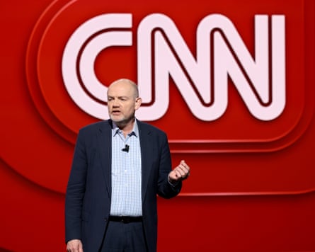 Mark Thompson in front of a large red and white CNN sign.