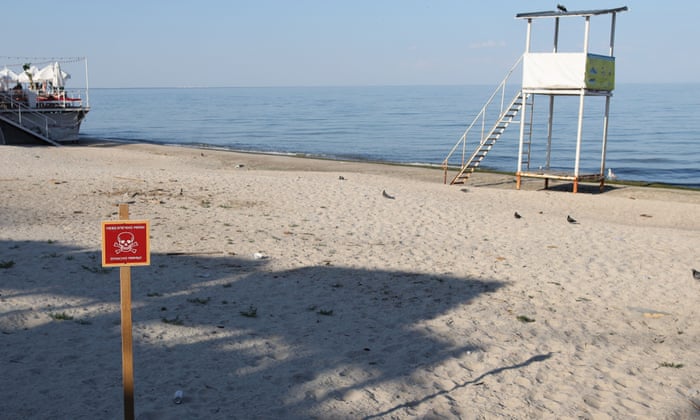 A beach in the Black Sea Ukrainian city of Odessa is deserted as locals take heed of signs warning of buried landmines.