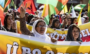 Syrian Kurdish women carry banners as they demonstrate against Turkish threats in north-eastern Syria, on 7 October.