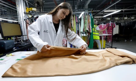 A worker inspects a garment at the Advanced Clothing Solutions facility in Motherwell, Scotland