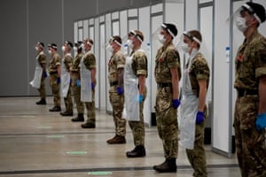Soldiers observe the two-minute silence at Liverpool Exhibition Centre, where the UK military are assisting with mass Covid-19 testing