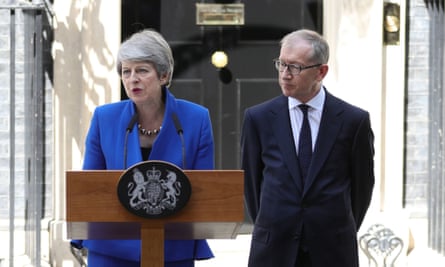 Theresa May reading her resignation statement outside 10 Downing Street, watched by her husband Philip, in July 2019