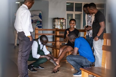 Agather Atuhaire shows some of her bruises and scars to colleagues at a hospital