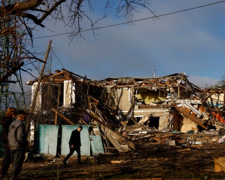Residents stand in front of a private building which was heavily damaged during a Russian missile strike in the town of Vyshhorod, amid Russia's attack on Ukraine.