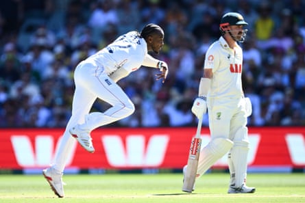 Jofra Archer bowls as Travis Head watches.
