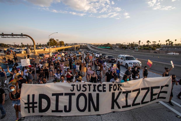 Protesters march on the 110 freeway in Los Angeles in protest over the shooting of Dijon Kizee.