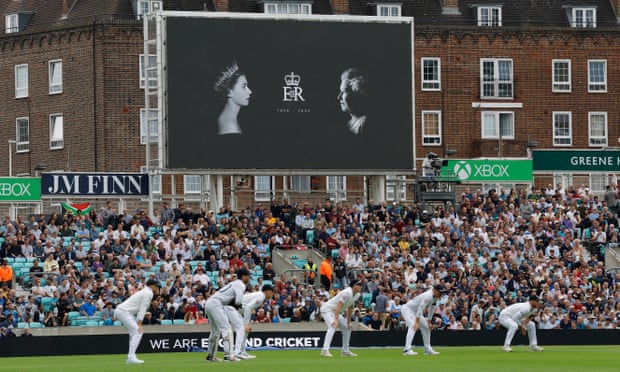 England slips in action, in front of a big screen paying tribute to Queen Elizabeth II