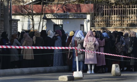 Afghan students queue at one of Kabul University’s gates in Kabul, Afghanistan, on Feb. 26, 2022.