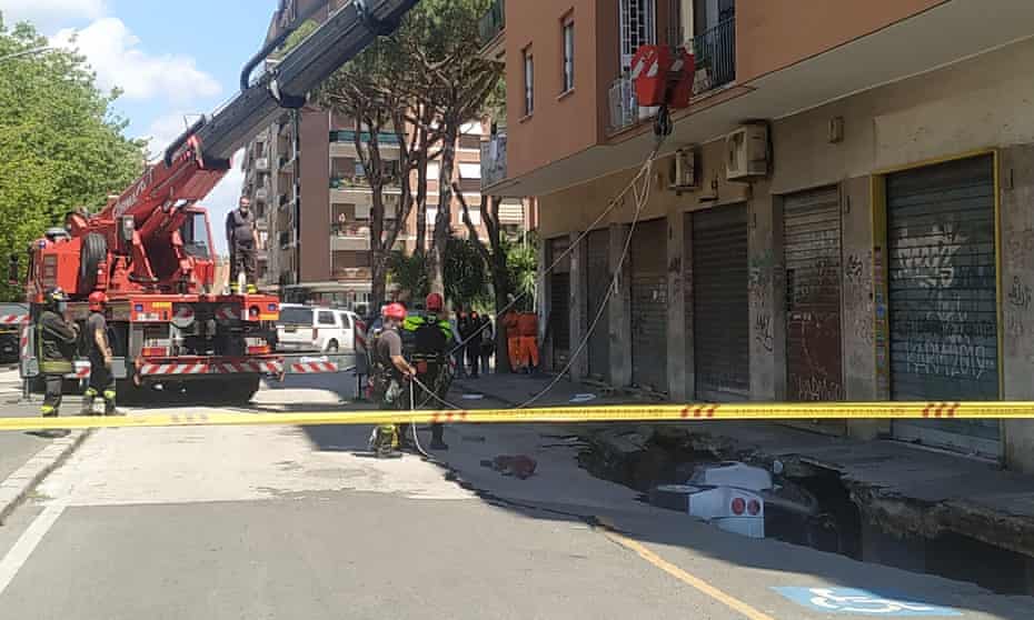 Emergency services at the scene of the sinkhole in Via Zenodossio, in the Torpignattara district of Rome