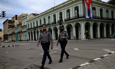 Police officers patrol the deserted streets of Havana on Monday after protest rallies were banned.