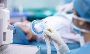 Nurse holding anaesthesia mask