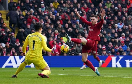 Chelsea goalkeeper Kepa Arrizabalaga saves at the feet of Liverpool's Andrew Robertson.