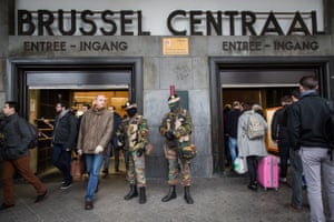 Soldiers stand guard at the entrance of Brussels’ central station