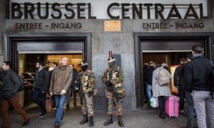 Soldiers stand guard at the entrance of Brussels’ central station