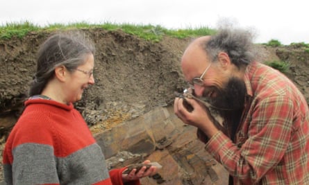 Dr Lucy Muir and Dr Joe Botting examine a fossil specimen at Castle Bank.