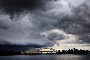Storm clouds are seen above the Sydney Opera House and the Harbour Bridge