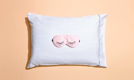 An illustration of a pillow with a picture of closed eyes on it