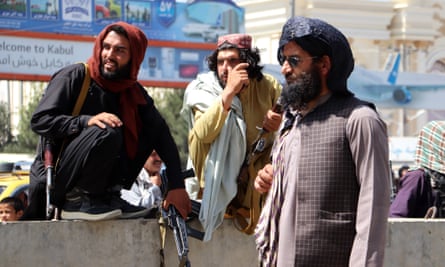 Taliban fighters stand guard outside Hamid Karzai international airport on Tuesday.