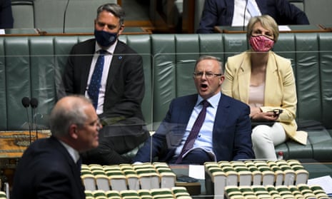 Australian Opposition Leader Anthony Albanese reacts as he listens to Australian Prime Minister Scott Morrison during House of Representatives Question Time at Parliament House in Canberra