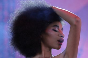 Closeup of Flowerovlove, she’s holding her hand on her head