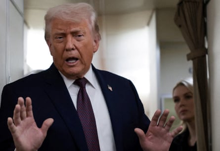 a man in a suit gestures with his hands