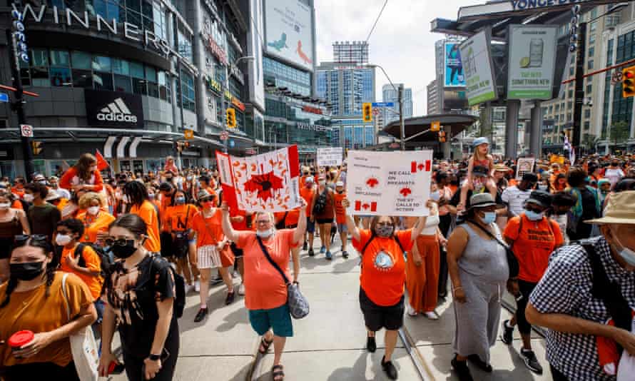 People march during the Every Child Matters walk in Toronto, Canada, on July 1, 2021, in honour of the Indigenous children.