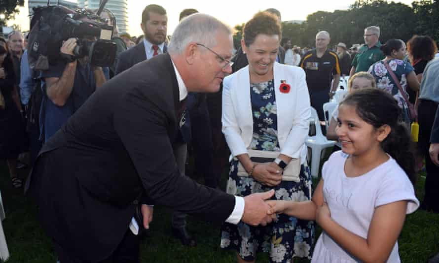 Prime Minister Scott Morrison mingles with members of the public after the Anzac Dawn Service at the Darwin Cenotaph on Day 15 of the 2022 federal election campaign, in Darwin, in the seat of Solomon. Monday, April 25, 2022. (AAP Image/Mick Tsikas)