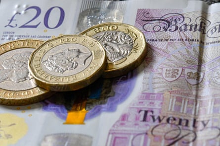 Two pounds coins and a £2 coin on a £20 note