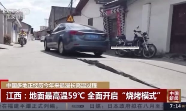 In a town in Jiangxi Province, state TV showed a heat-damaged section of a road arched up at least six inches.