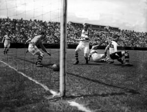 Belfast Celtic goalkeeper Kevin McAlinden and centre half Charlie Currie watch the ball head into the goal, during their 3-3 draw with Philadelphia Nationals on their 1949 tour of the USA.