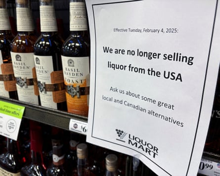 A sign beside bottles of wine reads ‘We are no longer selling liquor from the USA’